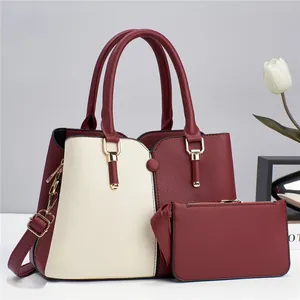 Burgundy and beige colorblock handbag set with matching clutch and gold metal details