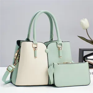 Detail view of two-piece handbag set featuring light green and beige pebble leather texture