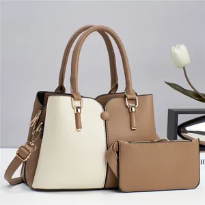 Detailed view of bicolor large tote bag set with matching pouch and gold-tone hardware