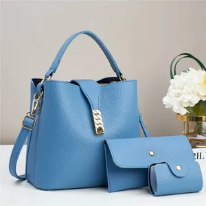 Three-piece set of blue pebble leather handbags with gold hardware and shoulder strap
