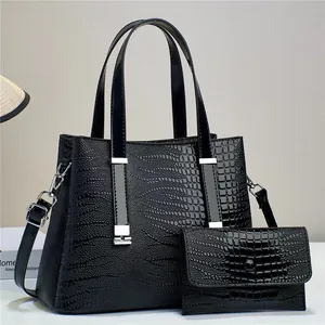 Detail of black lizard texture leather handbag and matching long wallet with silver hardware