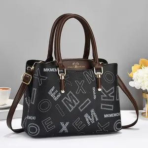 Classic black leather tote with white letter prints, brown handles and golden hardware