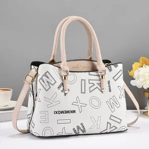 White faux leather handbag with black letter prints and beige handles for women