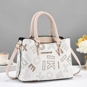 Detailed macro view of white pebble leather texture and golden brand logo engraving