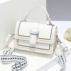 Chic white crossbody bag with geometric pattern wide strap and contrast stitching