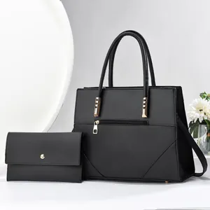 Two-piece black faux leather tote set with matching wallet and gold hardware detail