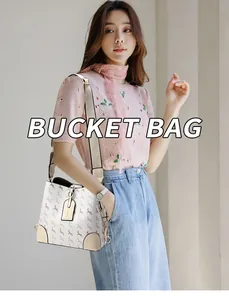 Detail view of stylish patterned bucket bag with wide strap and premium hardware