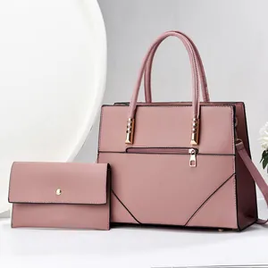 Detail view of pink PU leather tote and matching wallet with geometric stitching