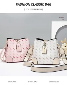Detail view of pink and white bucket bags with textured deer patterns and dual straps