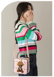 Pink box bag with teddy bear patch and deer pattern styled with a striped cardigan