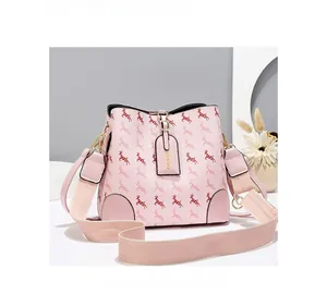 Detailed macro view of pink bucket bag with red deer prints and wide fabric strap