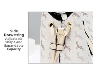 Detail view of side drawstring and gold hardware on beige patterned bucket bag