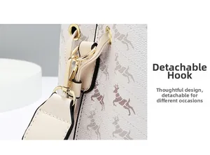 Detail of detachable golden metal hook on off-white bucket bag with elk pattern