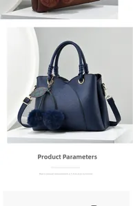 Close-up of litchi grain faux leather handbag with decorative plush cherry pendant