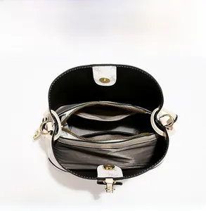 Detail shot of multi-compartment bucket bag with large capacity and magnetic buckle