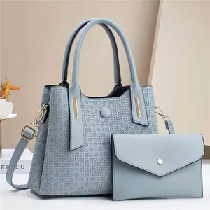 Light blue embossed tote bag set with matching pouch and adjustable shoulder strap