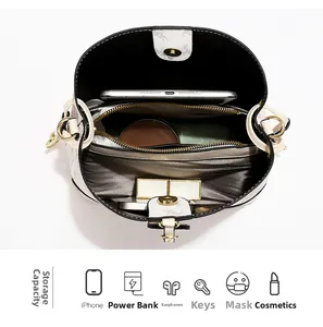 Interior detail of a bucket bag showing spacious compartments and golden zipper pocket