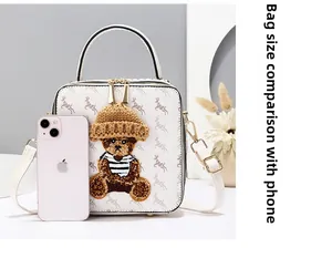 Size comparison between the bear print box bag and a smartphone for scale