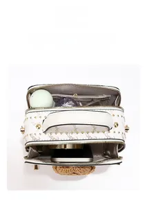 Interior view showing large capacity compartments for phone and cosmetics in printed box bag