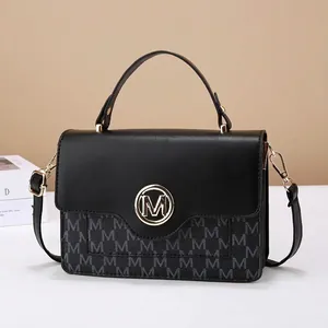 Classic black leather crossbody bag with gold M logo and letter pattern for women