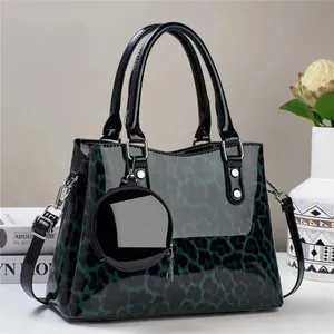 Detail of dark green leopard print handbag with glossy finish and matching coin purse