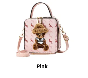 Close-up of pink square box bag with deer print and 3D teddy bear patch detail