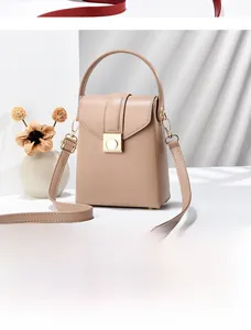 Dettaglio della mini borsa a tracolla in pelle kaki con chiusura a rotazione dorata