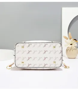 Close-up of bucket bag bottom with brown horse print and four gold protective metal studs