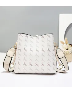 Detail of white bucket bag with elk pattern, textured faux leather and wide strap