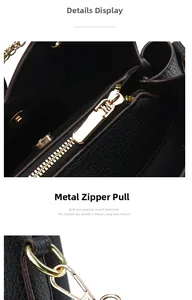Detail of high-quality gold hardware zipper puller on black litchi leather handbag