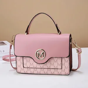 Pink crossbody bag with monogram pattern and gold metal logo for women fashion