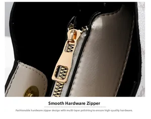 Detailed macro view of smooth gold hardware zipper and polished magnetic buckle on cream bag