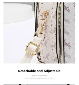 Detail view of the detachable and adjustable shoulder strap with gold-tone metal hardware