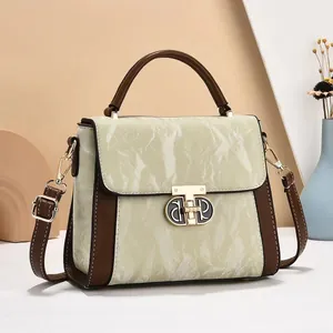 Women's two-tone crossbody handbag with marble texture flap and gold metal turn-lock
