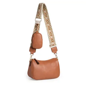 Brown leather saddle bag with ethnic embroidered strap and small coin purse attachment