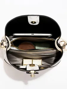 Chic cream bucket bag with multi-layer interior storage and golden hardware accents