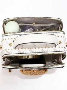 White box bag with giraffe print, gold rivets, and dual-compartment internal storage