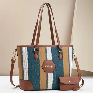 Detail of canvas striped tote with leather trim and matching mini coin purse