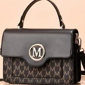 Fashionable black and brown monogram crossbody bag with golden M metal logo for women
