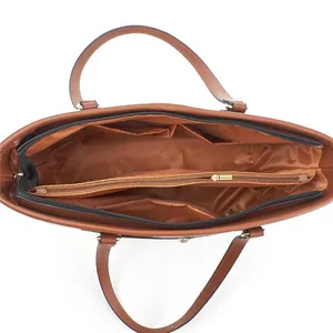 Detail view of large retro tote bag interior with multiple compartments and gold zippers
