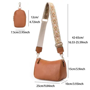 Brown lychee leather saddle bag dimensions with geometric strap and small pouch
