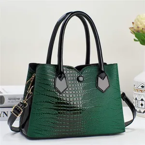 Dark green faux crocodile leather handbag with black patent trim and gold hardware