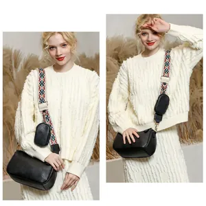 Detail of black saddle crossbody bag with geometric ethnic patterned wide strap and coin pouch