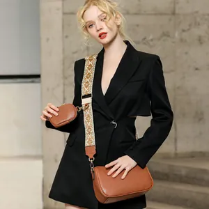 Brown saddle bag set with textured leather, round coin purse and patterned shoulder strap