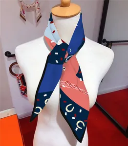 Detail of silk scarf with horse motif and geometric patterns on a white mannequin