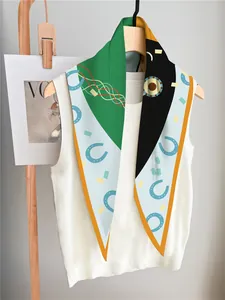Detail of silk-like scarf with green and yellow geometric horse bit print on white vest