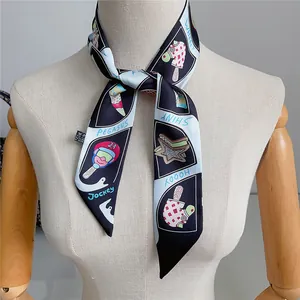 Detailed view of 100% polyester twilly scarf with cartoon motifs tied around a neck