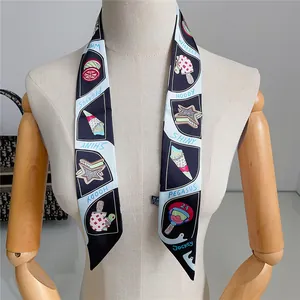 Detailed close-up of a luxury silk twilly scarf with cartoon illustrations on a mannequin