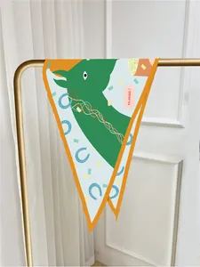 Detail of silk scarf with green horse pattern and orange border on a golden hanger
