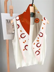 Detailed shot of the luxury heart and horse pattern silk scarf on a white vest